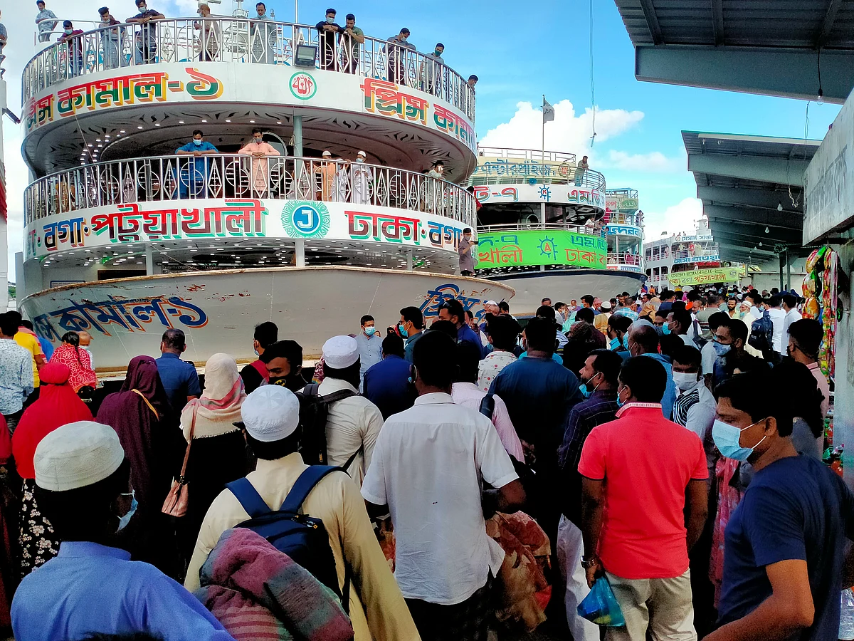 People bound for Dhaka try to board a launch in Patuakhali launch terminal on 22 July 2021, defying health rules amid Covid-19 outbreak as restrictions will come into force from 23 July following a week of relaxing during Eid-ul-Azha.
