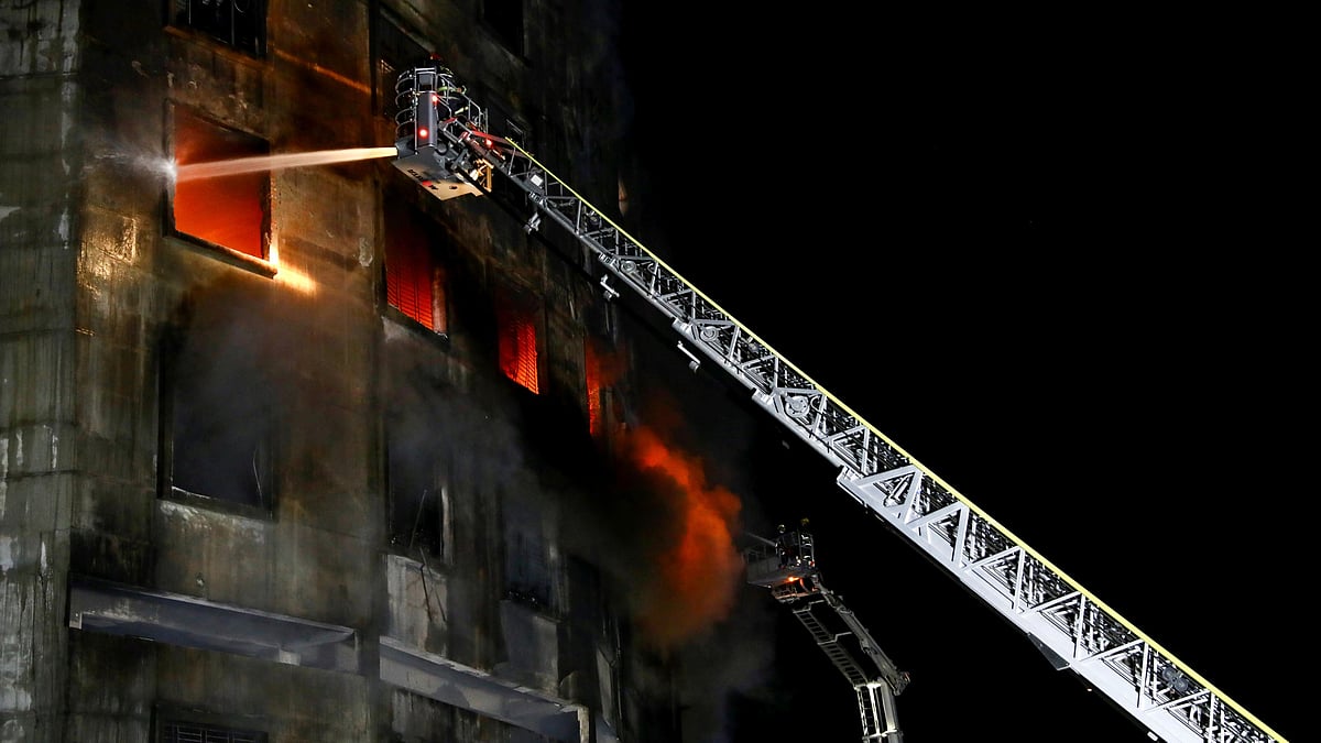 Firefighters work at the scene of a fire that broke out at a factory named Hashem Foods Ltd. in Rupganj of Narayanganj district, outskirts of Dhaka, Bangladesh, on 9 July 2021