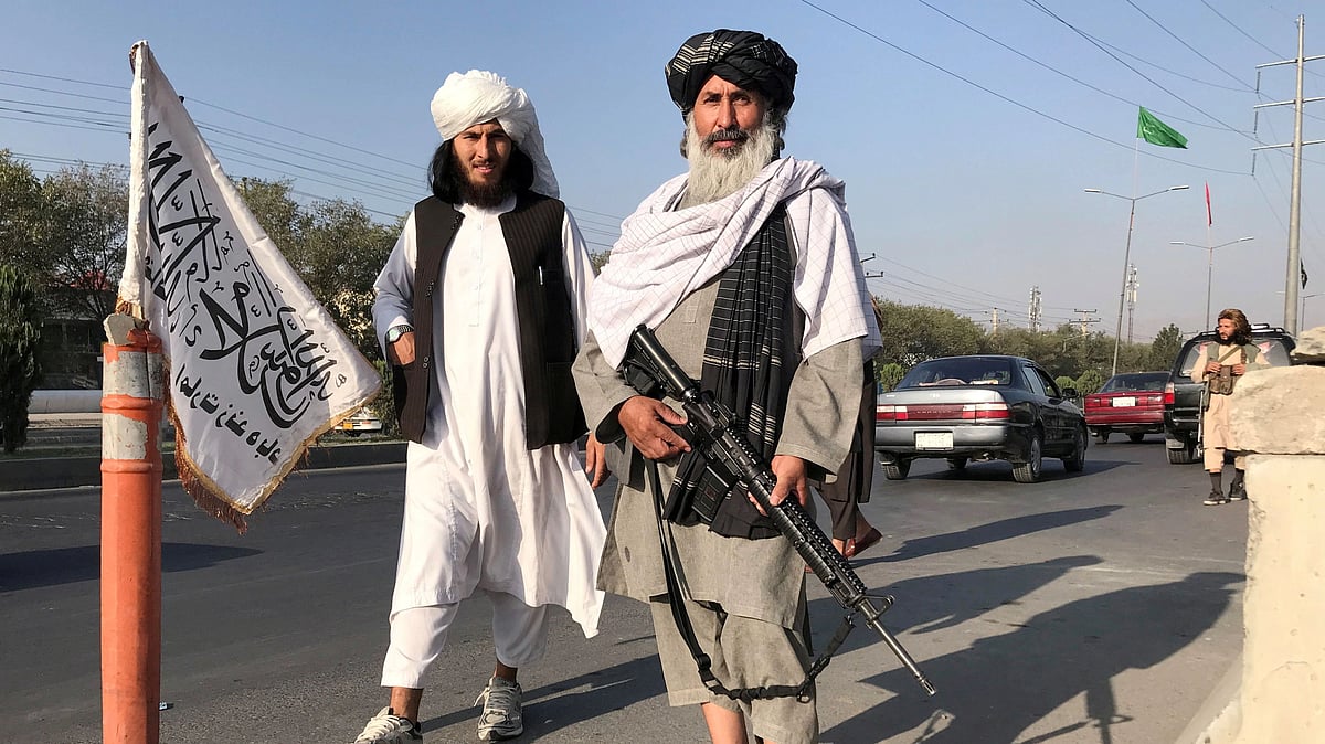 A Taliban fighter holding an M16 assault rifle stands outside the Interior Ministry in Kabul, Afghanistan, on 16 August 2021