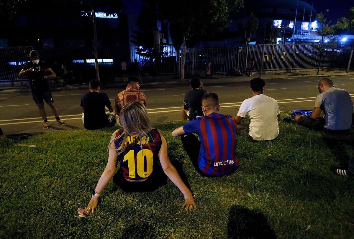FC Barcelona fans are seen outside the Camp Nou after FC Barcelona announced Lionel Messi will leave the club