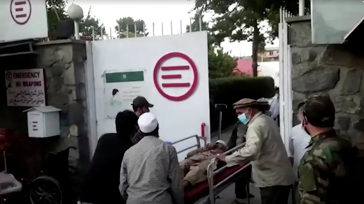 A screen grab shows people carrying an injured person to a hospital after an attack at Kabul airport, in Kabul, Afghanistan on 26 August 2021