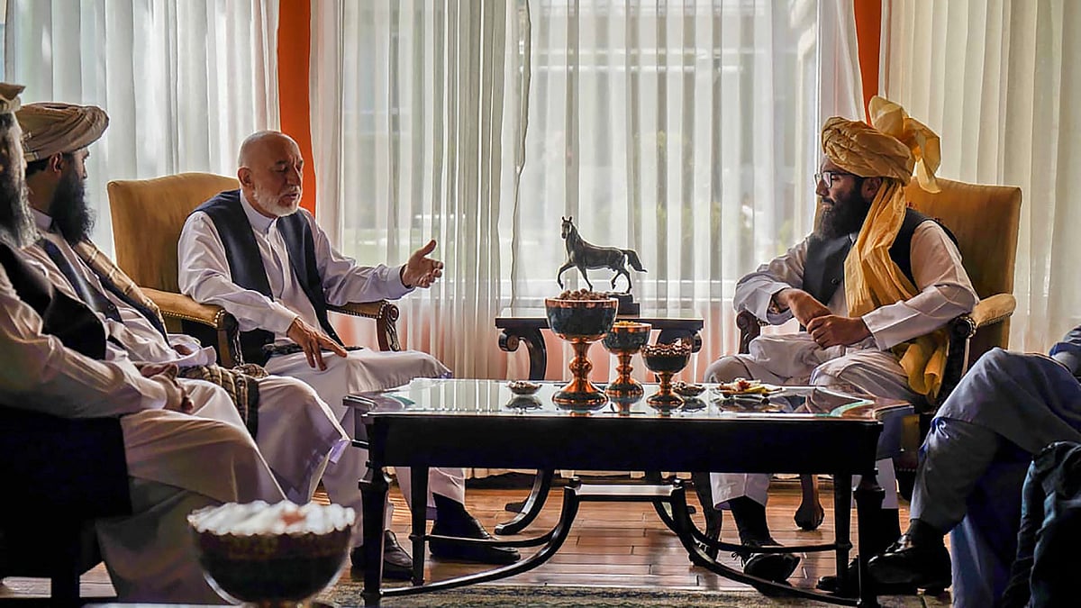 - This handout photo released by the Arabic Twitter account of the "Islamic Emirate of Afghanistan" on 18 August, 2021 shows a Taliban delegation led by the head of the negotiating team Anas Haqqani (C-R) meeting with former Afghan government officials including former president Hamid Karzai (C-L) at an unspecified location in Afghanistan