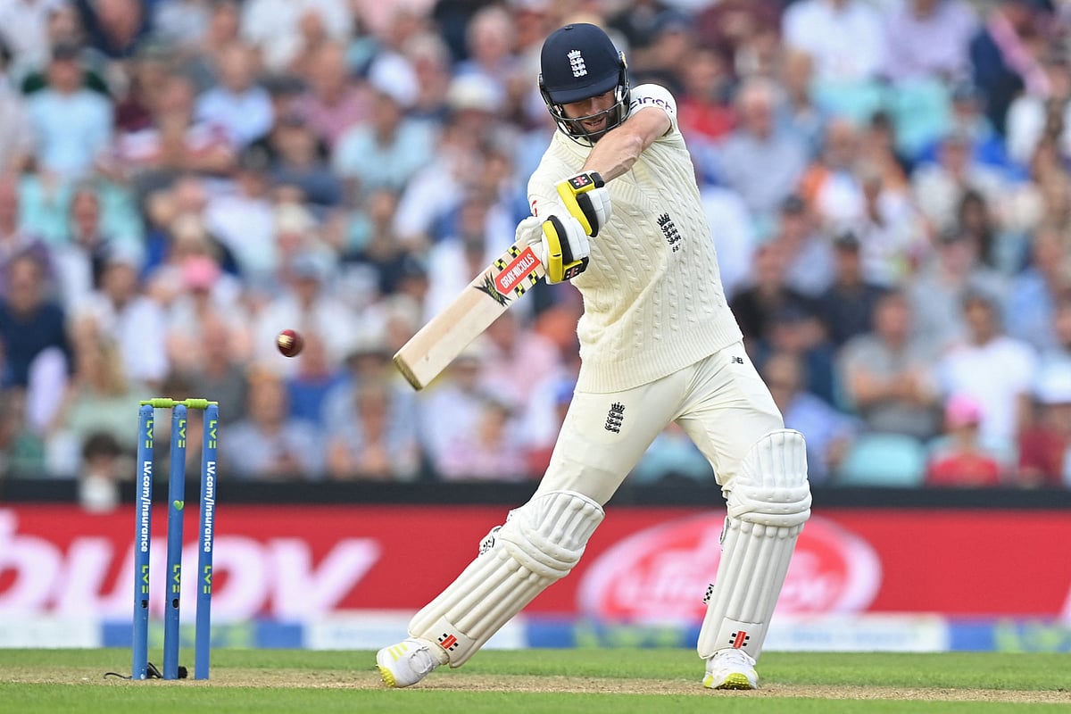 England's Chris Woakes plays a shot during play on the second day of the fourth cricket Test match between England and India at the Oval cricket ground in London
