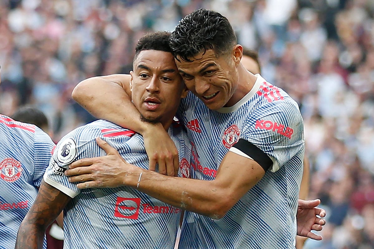 Manchester United's English midfielder Jesse Lingard (L) celebrates with Manchester United's Portuguese striker Cristiano Ronaldo (R) after scoring their second goal during the English Premier League football match between West Ham United and Manchester United at The London Stadium, in east London on 19 September, 2021