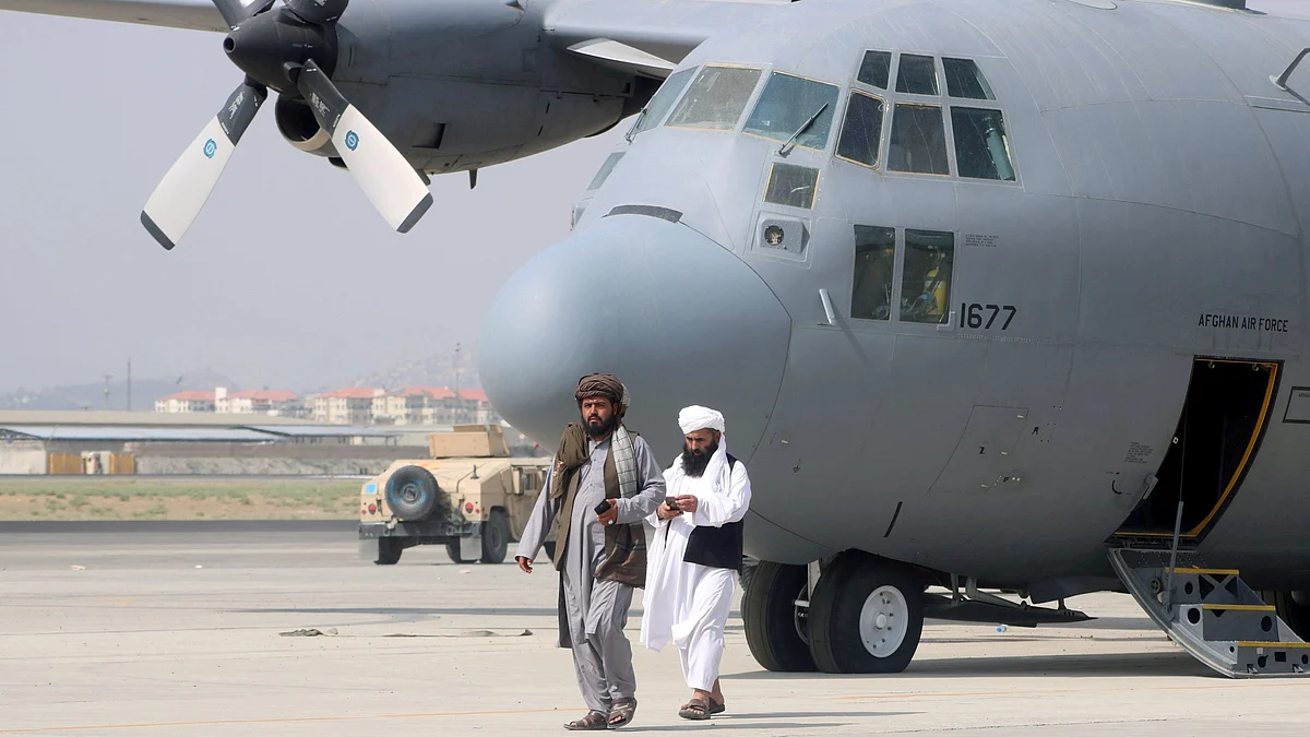 Taliban walk in front of a military airplane a day after the U.S. troops withdrawal from Hamid Karzai International Airport in Kabul, Afghanistan on 31 August 2021