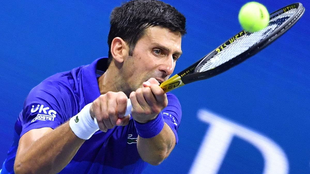 Serbia's Novak Djokovic hits a return to Denmark's Holger Rune during their 2021 US Open Tennis tournament men's singles first round match at the USTA Billie Jean King National Tennis Center in New York, on 31 August, 2021