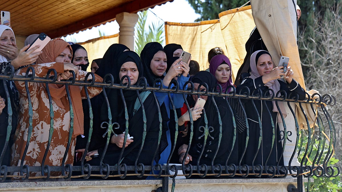 Relatives mourn during the funeral of Osama Sobh, a Palestinian man killed by Israeli soldiers during clashes near Jenin, in the village of Burqin in the Israeli occupied West Bank on 26 September 2021.