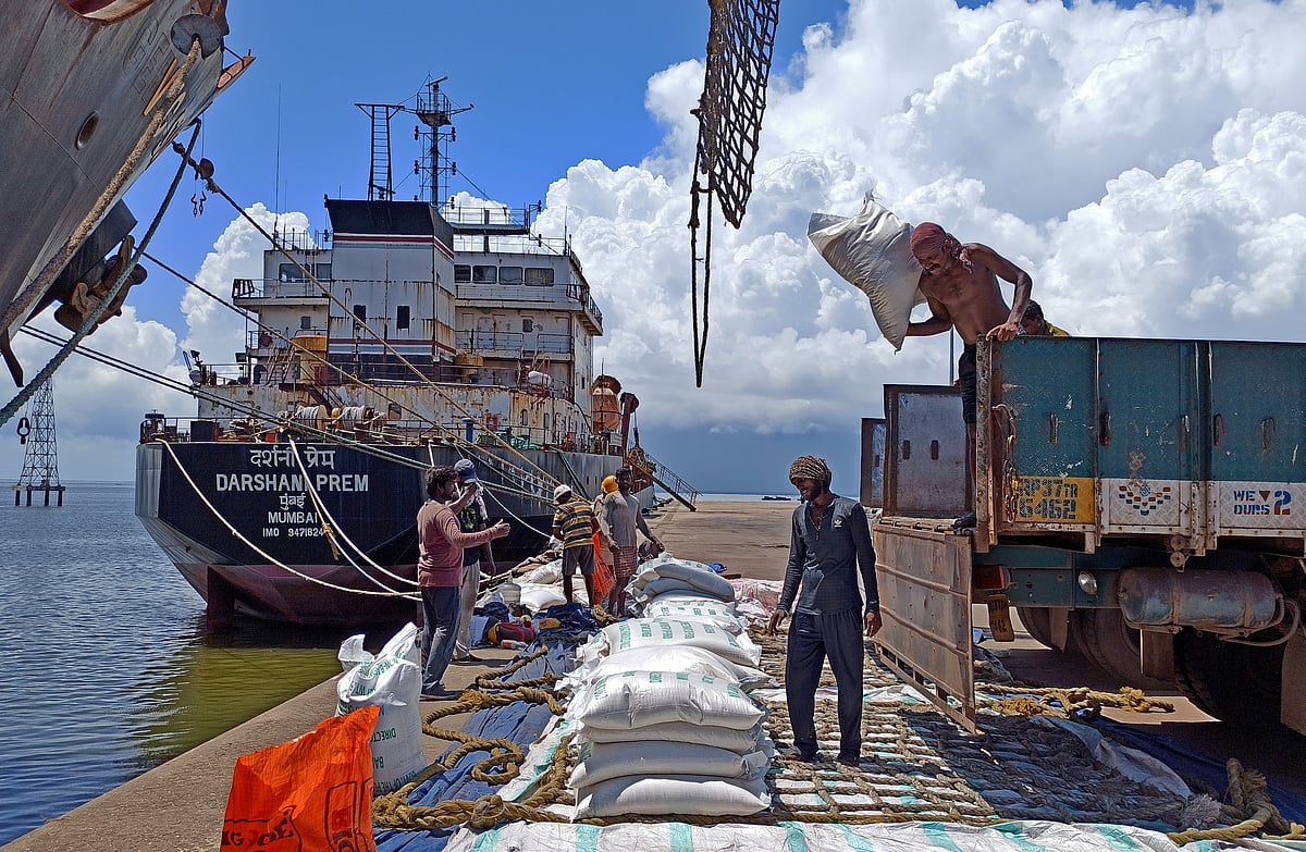 Labourers unload rice bags from a supply truck at India's main rice port at Kakinada Anchorage in the southern state of Andhra Pradesh, India on 2 September 2021.