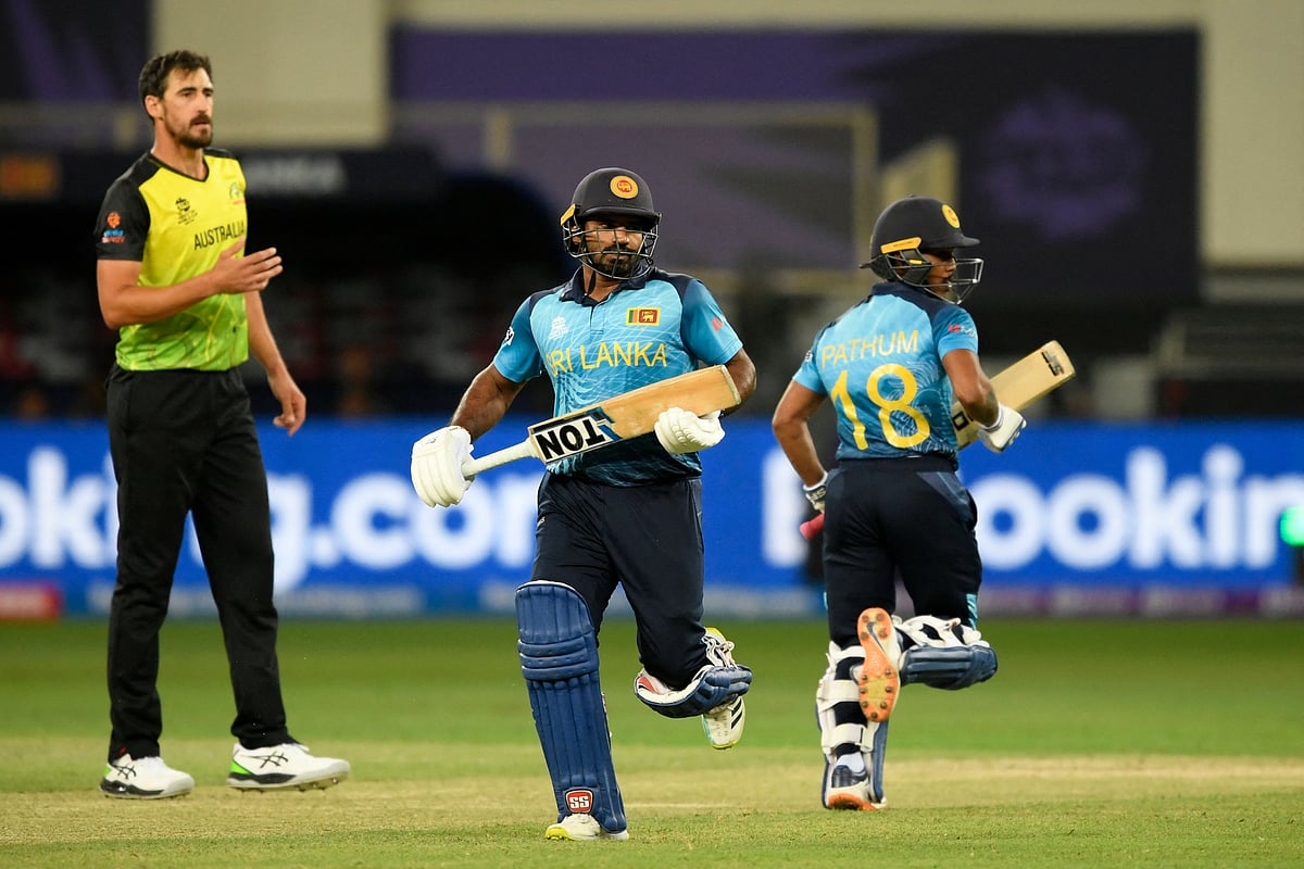 ustralia's Mitchell Starc (L) reacts as Sri Lanka's Kusal Perera (C) and Pathum Nissanka run between the wickets during the ICC men’s Twenty20 World Cup cricket match between Australia and Sri Lanka at the Dubai International Cricket Stadium in Dubai on 28 October, 2021