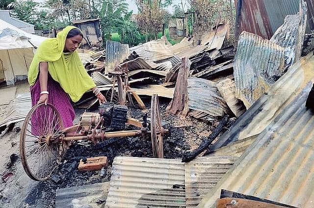 Nanda Rani moving away the rickshaw van burnt to ashes in the attack by frenzied mobs. Picture taken on Wednesday afternoon.
