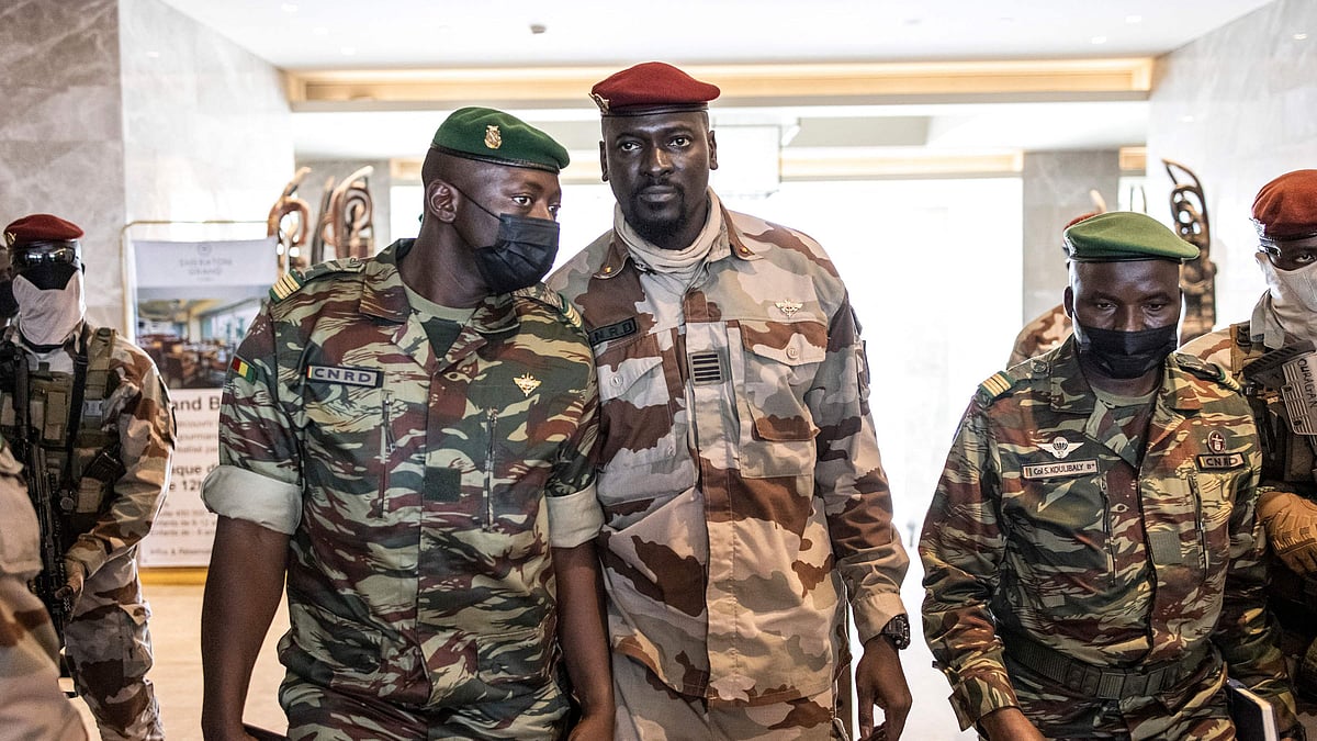 In this file photograph taken on 17 September 2021, president of the National Committee for Rally and Development (CNRD) Colonel Mamady Doumbouya (C) leaves a meeting with high level representatives of the Economic Community of West African States (ECOWAS) in Conakry.