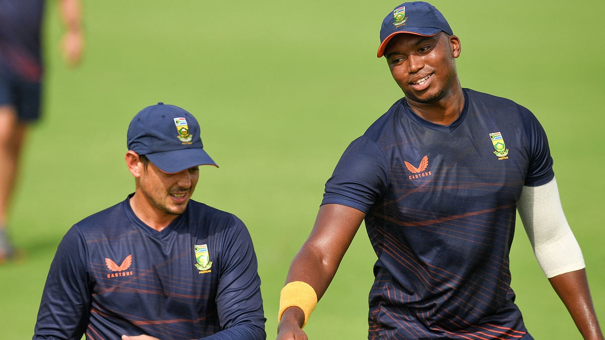 South Africa's Quinton De Kock (L) and his teammate Lungi Ngidi attend a practice session ahead of the ICC men's Twenty20 World Cup cricket match between South Africa and West Indies at the Sheikh Zayed Cricket Stadium in Abu Dhabi on 25 October 2021.
