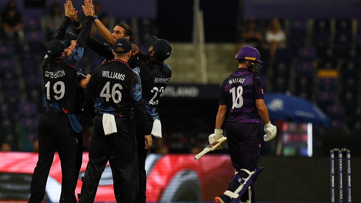 Namibia's cricketers celebrates after the dismissal of Scotland's Craig Wallace (R) during the ICC men’s Twenty20 World Cup cricket match between Scotland and Namibia at the Sheikh Zayed Cricket Stadium in Abu Dhabi on 27 October, 2021