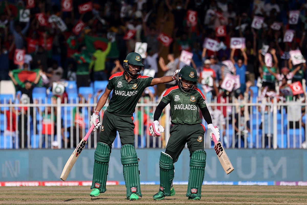 Bangladesh's Mohammad Naim (L) gestures to his teammate Mushfiqur Rahim during the ICC men’s Twenty20 World Cup cricket match between Sri Lanka and Bangladesh at the Sharjah Cricket Stadium in Sharjah on October 24, 2021