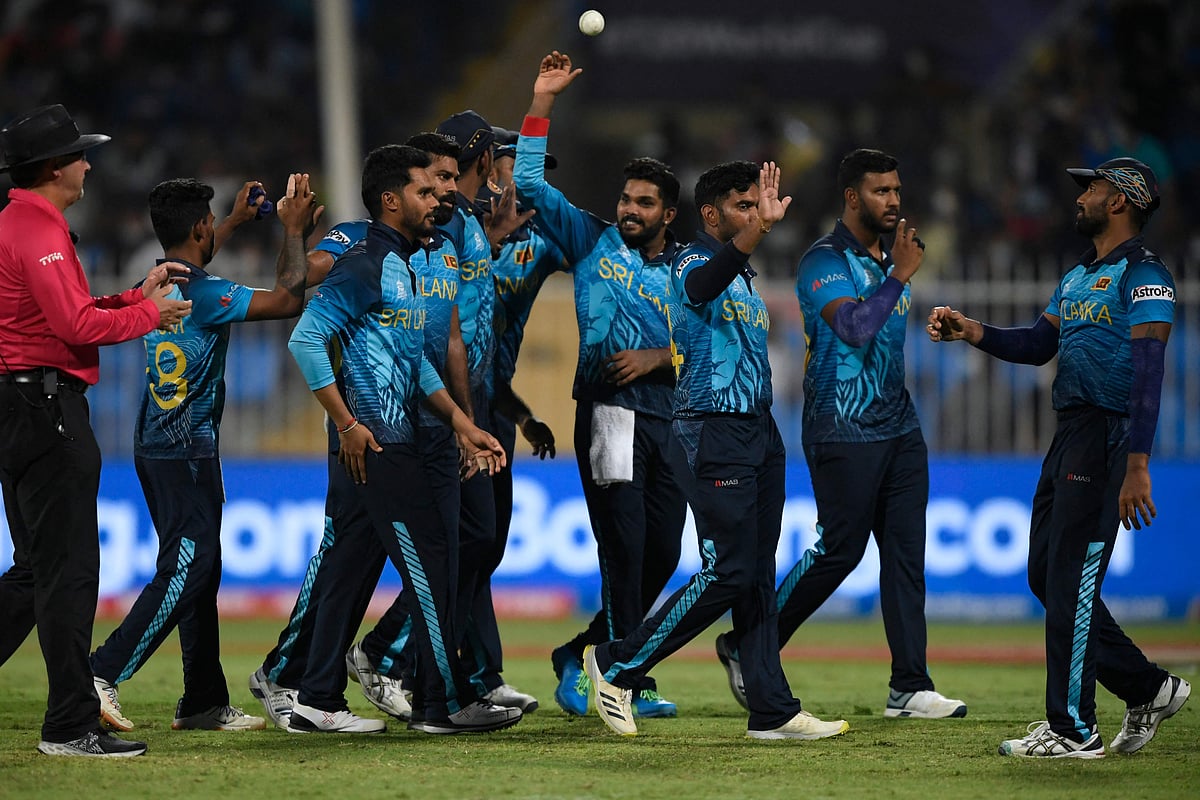 Sri Lanka's cricketers celebrate the dismissal of Netherland's Paul van Meekeren (not pictured) during the ICC men’s Twenty20 World Cup cricket match between Sri Lanka and Netherlands at the Sharjah Cricket Stadium in Sharjah on 22 October, 2021