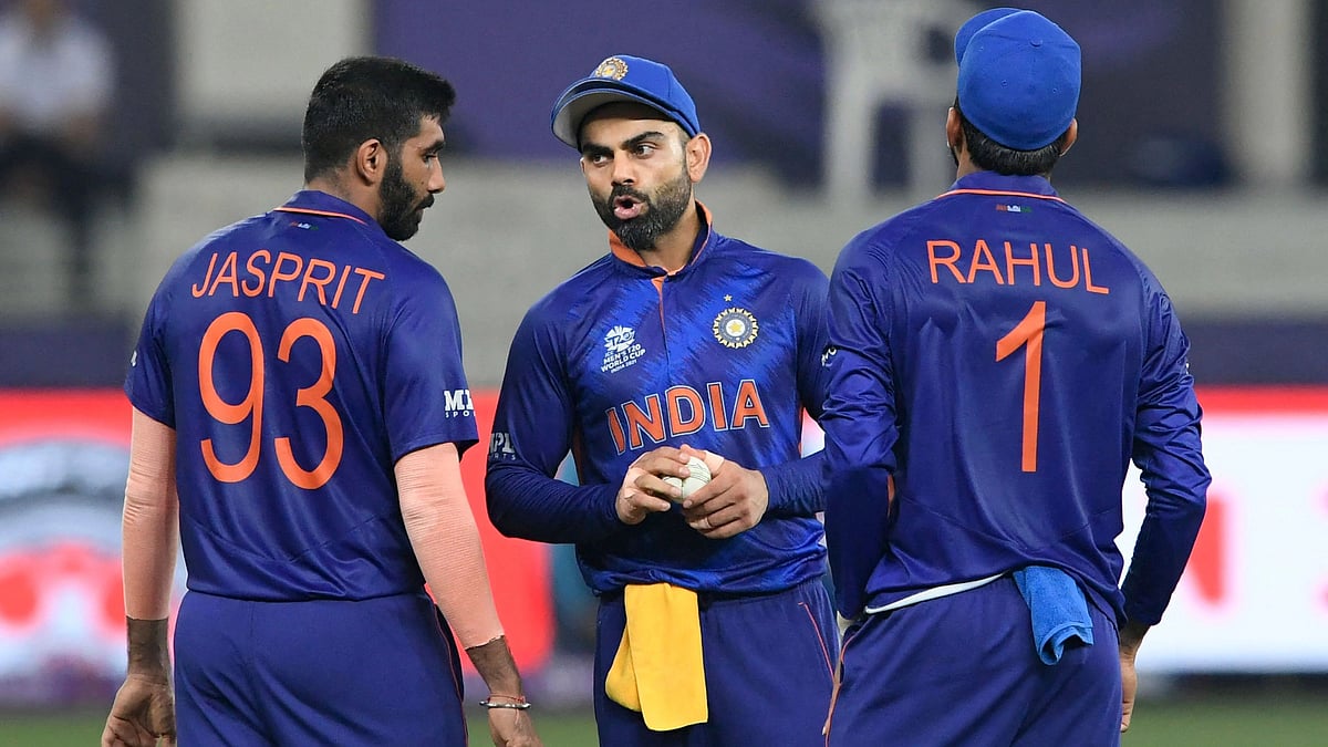 India's captain Virat Kohli (C) speaks with teammates Jasprit Bumrah (L) during the ICC men’s Twenty20 World Cup cricket match between India and Pakistan at the Dubai International Cricket Stadium in Dubai on 24 October 2021