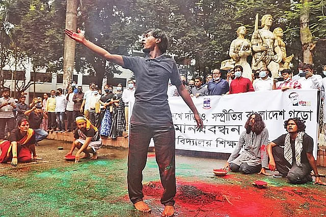 Dhaka University Teachers Association forms a human chain against communalism. The theatre and performance studies department of the university staged a street play after the human chain programme. Tuesday, in front of Aparajeo Bangla