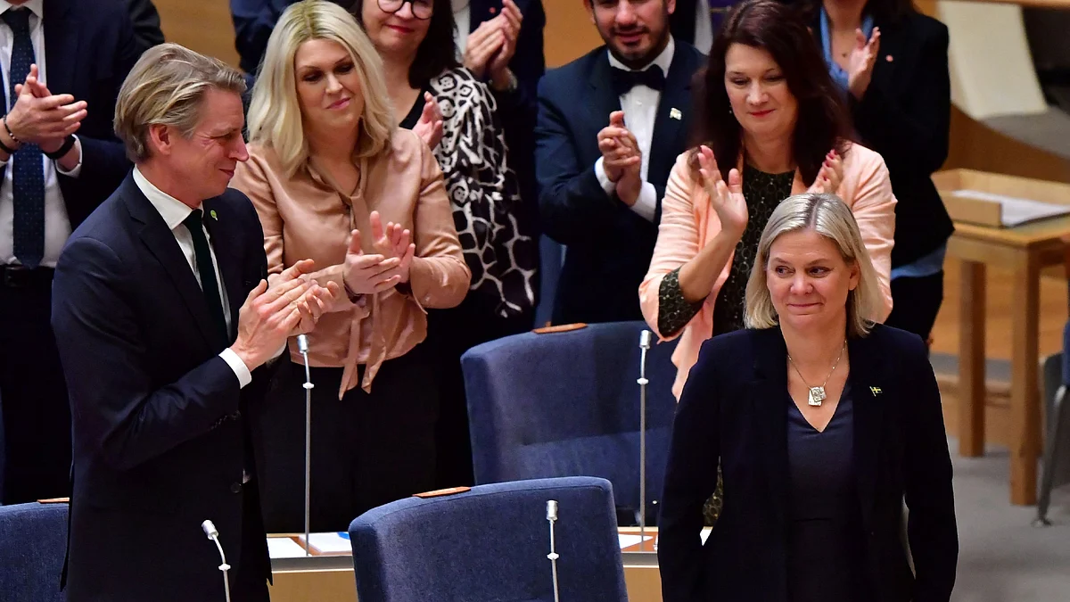 Current Swedish Finance Minister and Scocial Democratic Party leader Magdalena Andersson (R) receives applause after Swedish parliament Riksdagen voted for the second time on her appointment as prime minister in Stockholm on 29 November, 2021