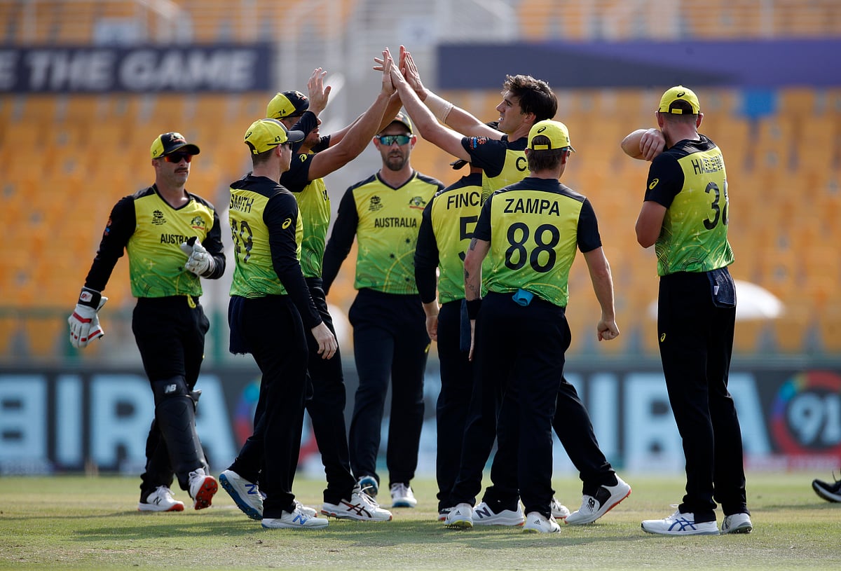 Australia's Pat Cummins celebrates taking the wicket of West Indies' Chris Gayle with teammates in the ICC men’s Twenty20 World Cup cricket match between Australia and West Indies at Zayed Cricket Stadium, Abu Dhabi, United Arab Emirates on 6 November 2021.