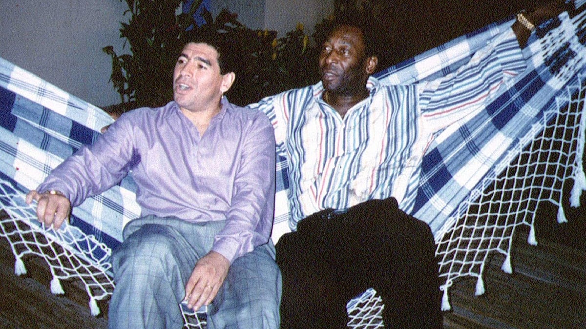 Soccer legends Diego Maradona (L) and Pele rest on a hammock during a reception in Rio de Janeiro, 14 May, 1995