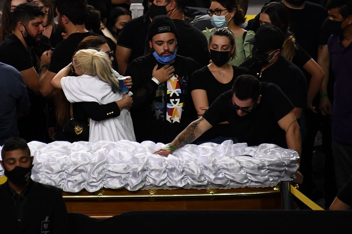 Relatives and friends mourn next to the coffin of Brazilian singer Marilia Mendonca, during her wake at the Arena Goiania sports centre, in Goiania, state of Goias, Brazil, on 6 November 2021