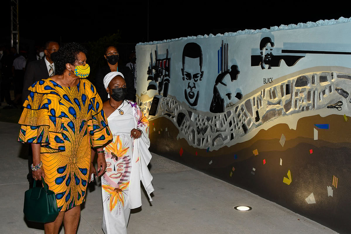 President-elect Dame Sandra Mason ( L) looks at the 1937 memorial wall with Stacia Bryan ( R), head of festivals and events at the National Cultural Foundation, after the official opening of Golden Square Freedom Park in Bridgetown, Barbados, on 27 November 2021