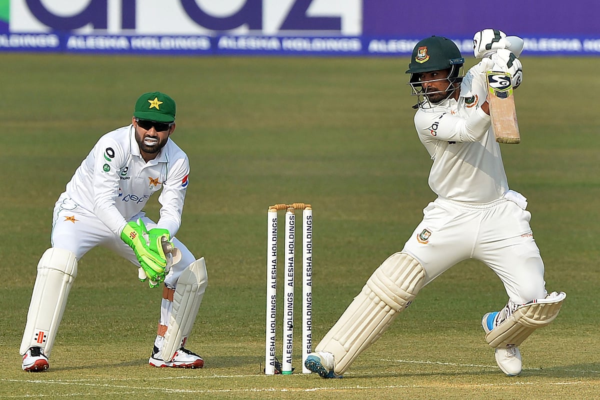 Liton Das (R) plays a shot as Pakistan's wicketkeeper Mohammad Rizwan watches during the first day of the first Test cricket match between Bangladesh and Pakistan at the Zahur Ahmed Chowdhury Stadium in Chittagong on 26 November, 2021.