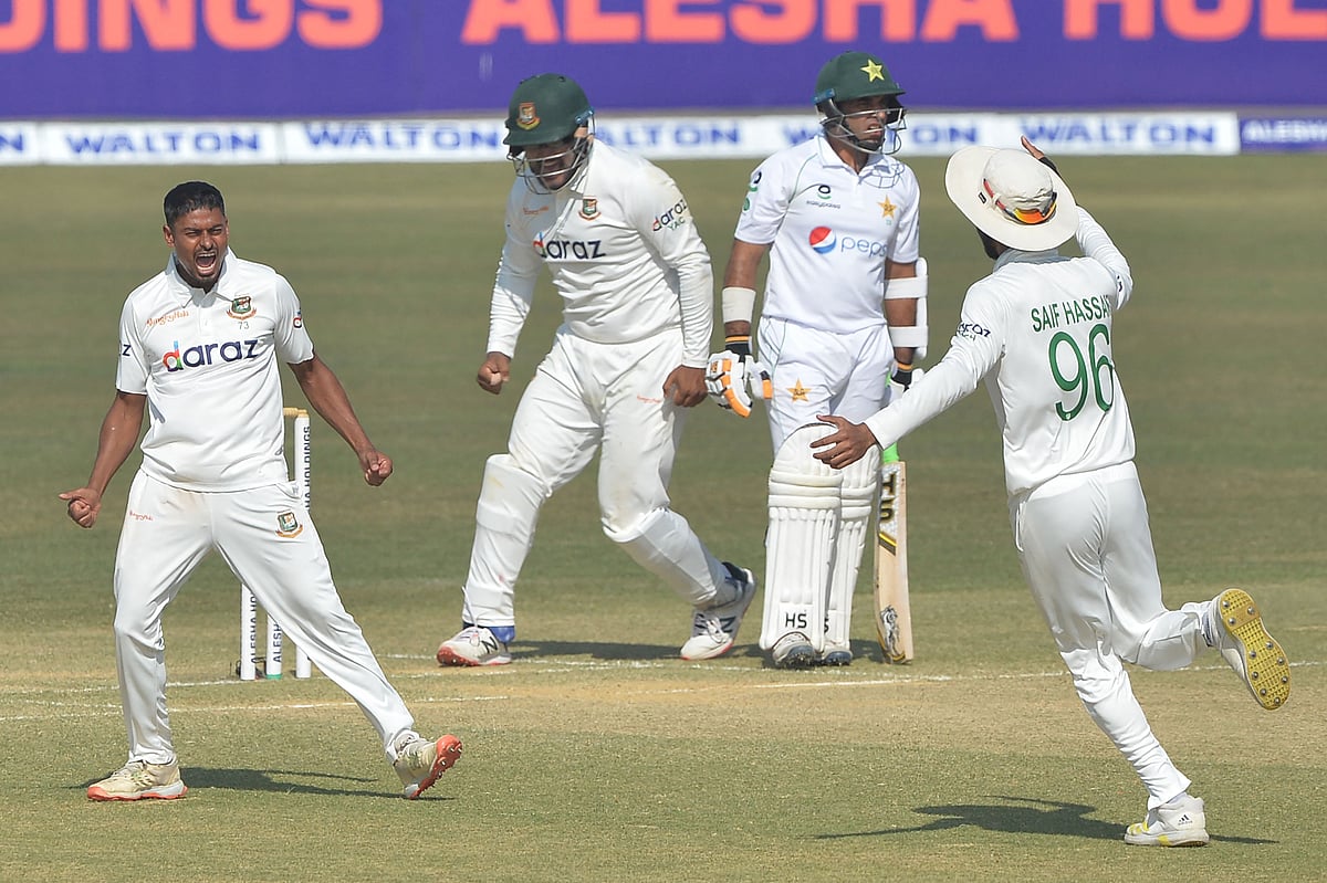 Bangladesh's Taijul Islam (L) celebrates after the dismissal of Pakistan's Abid Ali during the third day of the first Test cricket match between Bangladesh and Pakistan at the Zahur Ahmed Chowdhury Stadium in Chittagong on 28 November, 2021