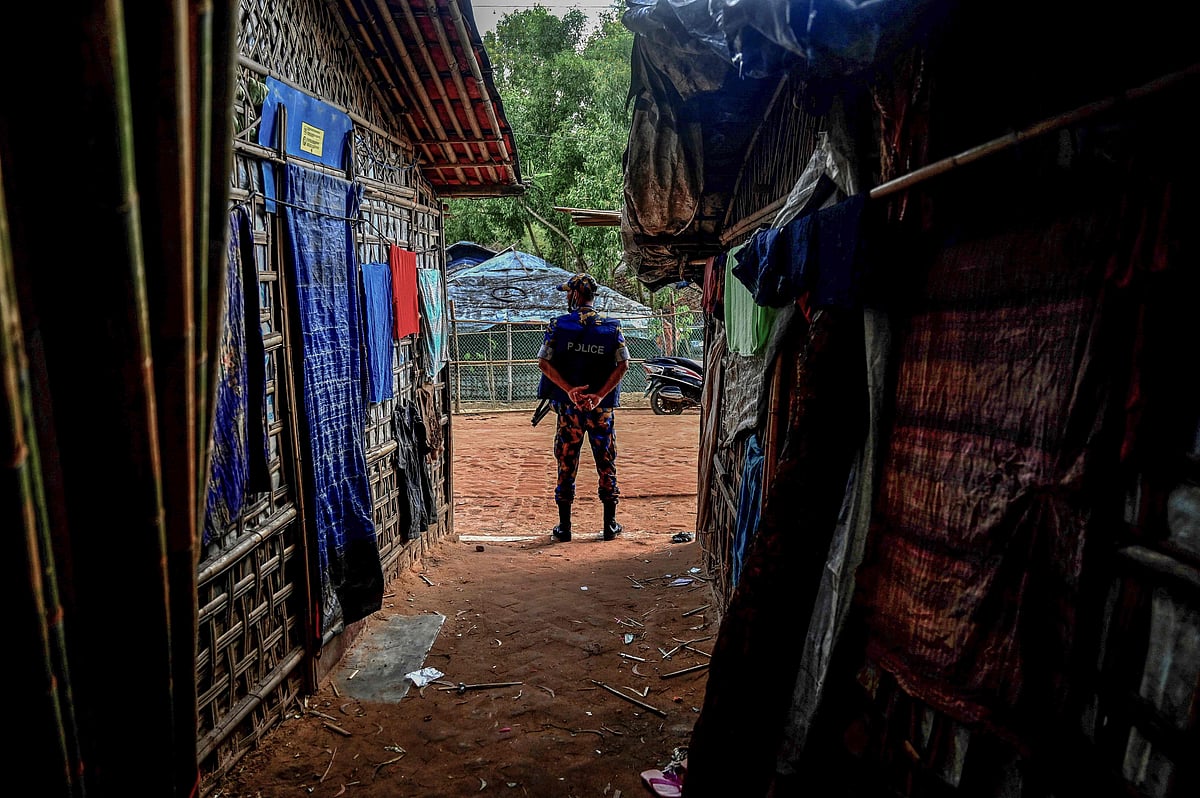 In this picture taken on 5 October, 2021 a member of the Armed Police Battalion stands guard near the office of top community Rohingya leader and activist Mohib Ullah