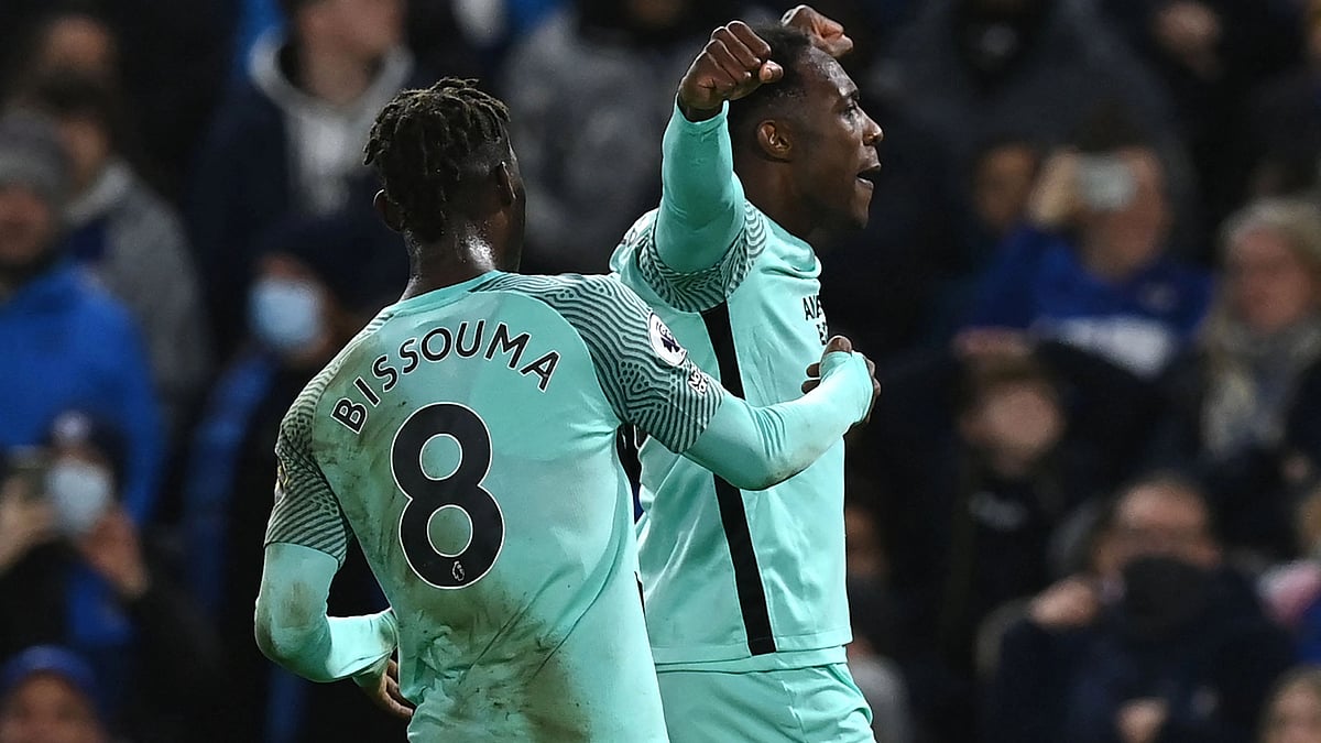 Brighton's English striker Danny Welbeck (R) celebrates after he scores his team's opening goal during the English Premier League football match between Chelsea and Brighton and Hove Albion at Stamford Bridge in London on 29 December, 2021
