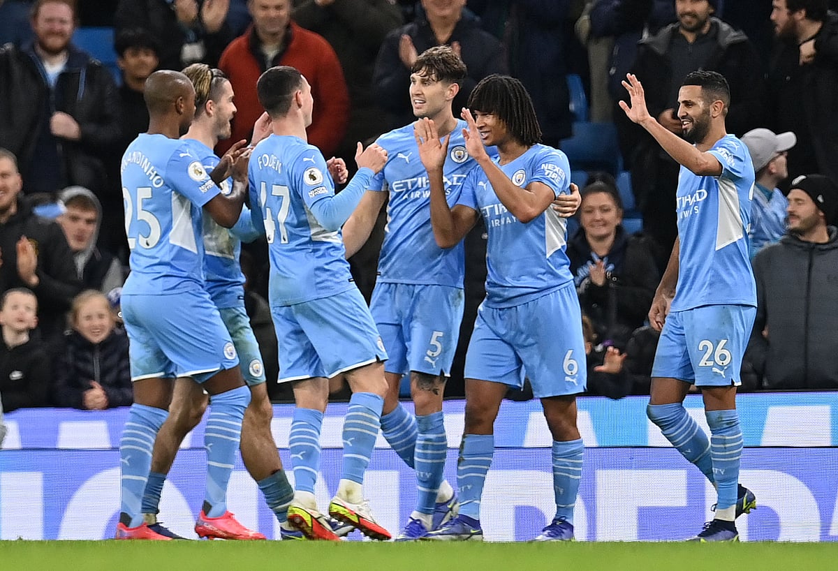 Manchester City's Dutch defender Nathan Ake (2R) celebrates scoring his team's seventh goal with teammates during the English Premier League football match against Leeds at the Etihad Stadium in Manchester, north west England, on December 14, 2021
