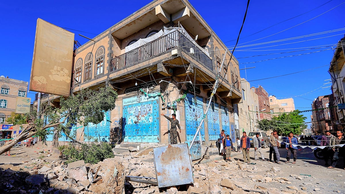 Yemenis inspect damage following a reported overnight air strike by the Saudi-led coalition targeting in the Huthi rebel-held capital Sanaa, on 24 December, 2021