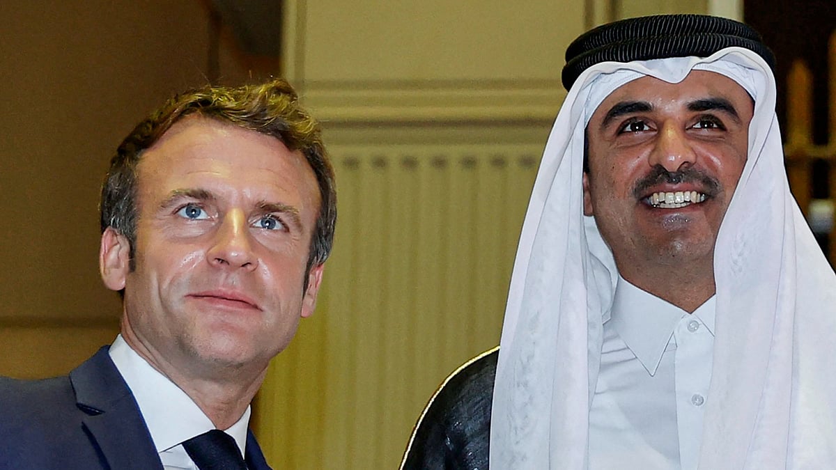 Qatar's Emir Sheikh Tamim bin Hamad Al-Thani (R) receives French President Emmanuel Macron (L) at the Amiri Diwan in the capital Doha on 3 December 2021.