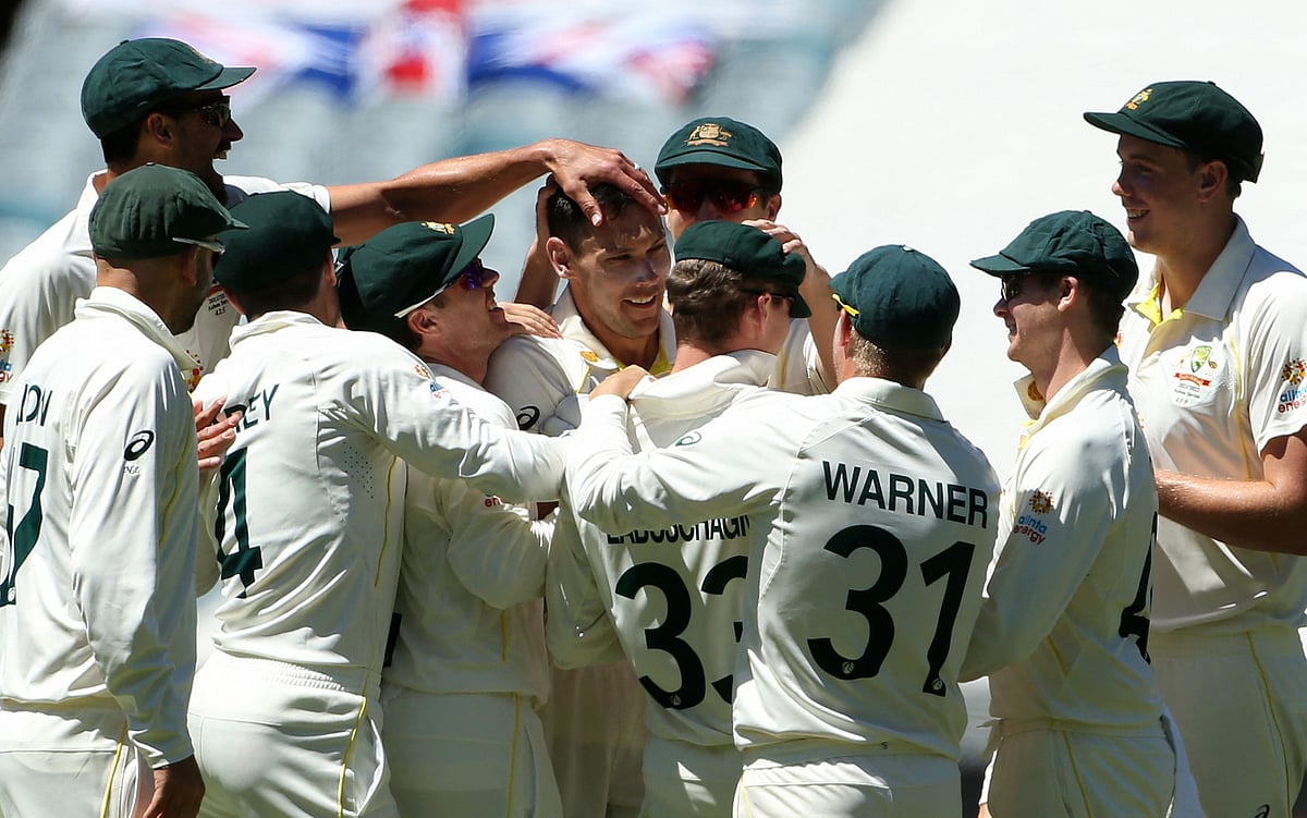 Australia's paceman Scott Boland (C) celebrates the wicket of England's batsman Ollie Robinson (not pictured) with teammates during the third day of the third Ashes cricket Test match in Melbourne on 28 December, 2021