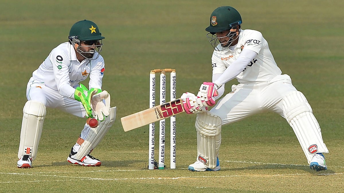 Bangladesh's Mushfiqur Rahim (R) plays a shot as Pakistan's wicketkeeper Mohammad Rizwan watches during the first day of the first Test cricket match between Bangladesh and Pakistan at the Zahur Ahmed Chowdhury Stadium in Chittagong on 26 November, 2021