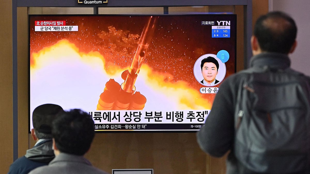 People watch a television screen showing a news broadcast with file footage of a North Korean missile test, at a railway station in Seoul on 25 January, 2022, after North Korea fired two suspected cruise missiles according to the South's military
