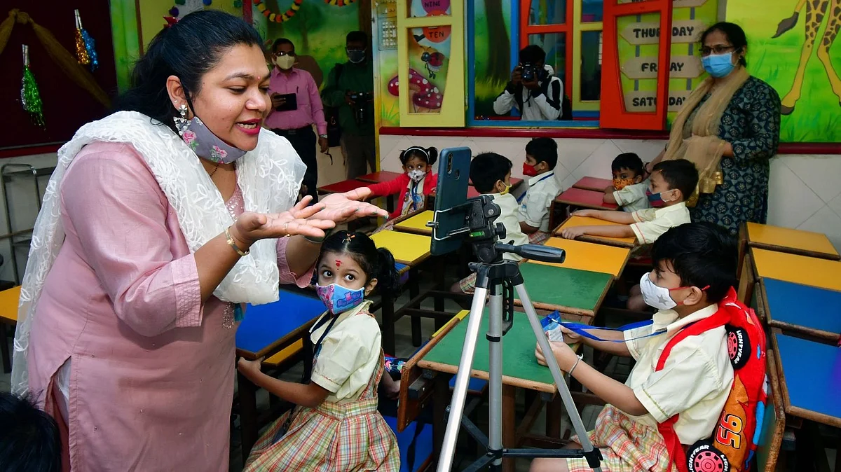 A teacher teaches students after schools re-opens, in Mumbai on 24 January 2022
