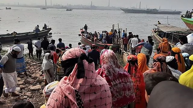 Relatives of the missing passengers wait on the banks of Dhaleshwari river on 5 January, 2022