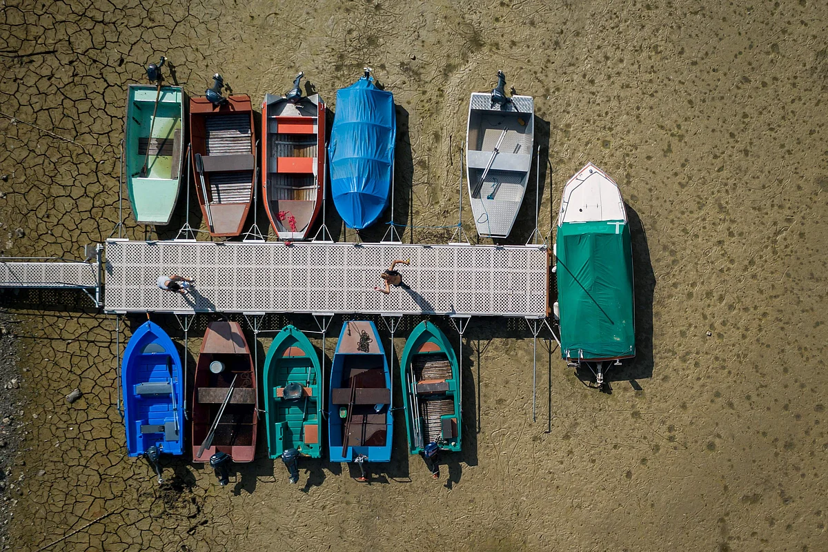 his aerial file photo taken on September 20, 2018 shows boats beside a jetty on the dried out bed of the Brenet Lake (French: Lac des Brenets) part of the Doubs river, a natural border beetwen eastern France and western Switzerland, on 20 September, 2018 in Les Brenets