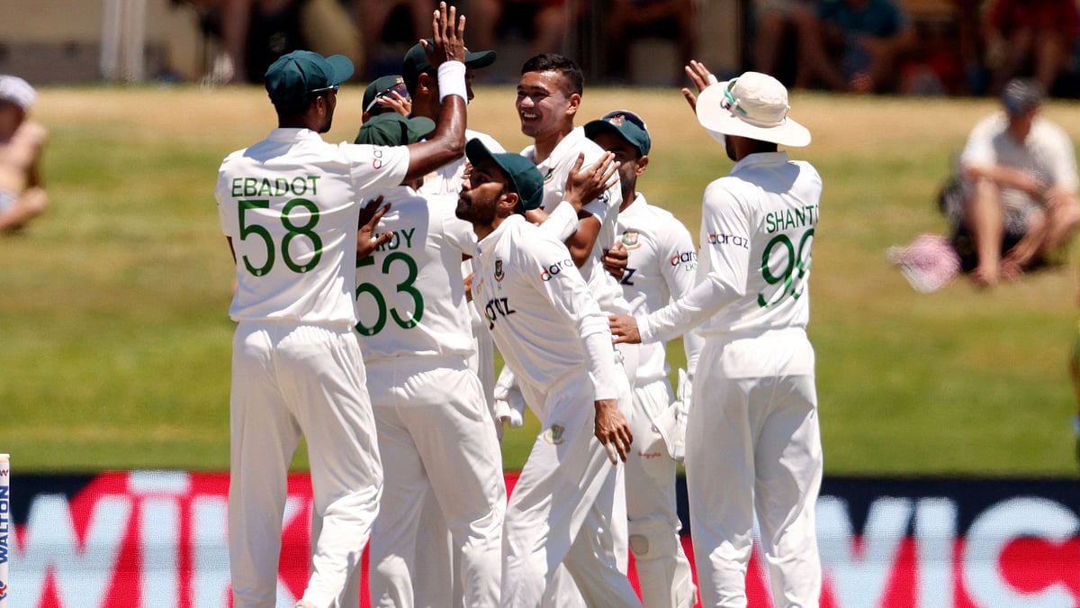 Bangladesh's players celebrate the wicket of New Zealand’s Tom Latham during the fourth day of the first cricket Test match between New Zealand and Bangladesh at the Bay Oval in Mount Maunganui on 4 January, 2022