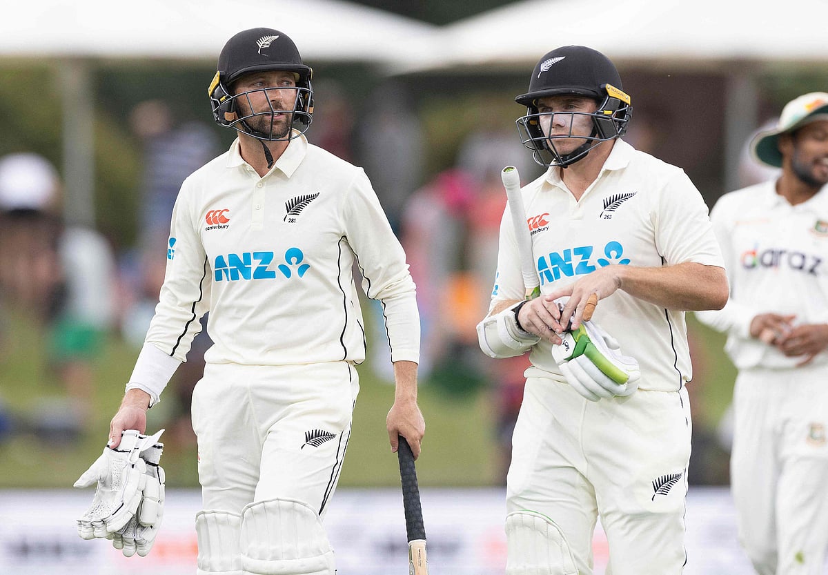 New Zealand's Devon Conway (L) and captain Tom Latham walk off the field at the end of play during the second cricket Test match between New Zealand and Bangladesh in Christchurch on 9 January 2022