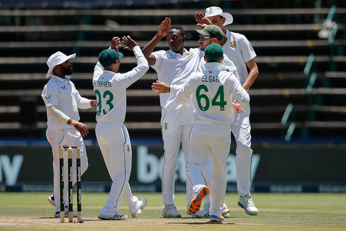 South Africa's Kagiso Rabada (C) celebrates with teammates after the dismissal of India's Rishabh Pant (not seen) during the third day of the second Test cricket match between South Africa and India at The Wanderers Stadium in Johannesburg on 5 January 2022