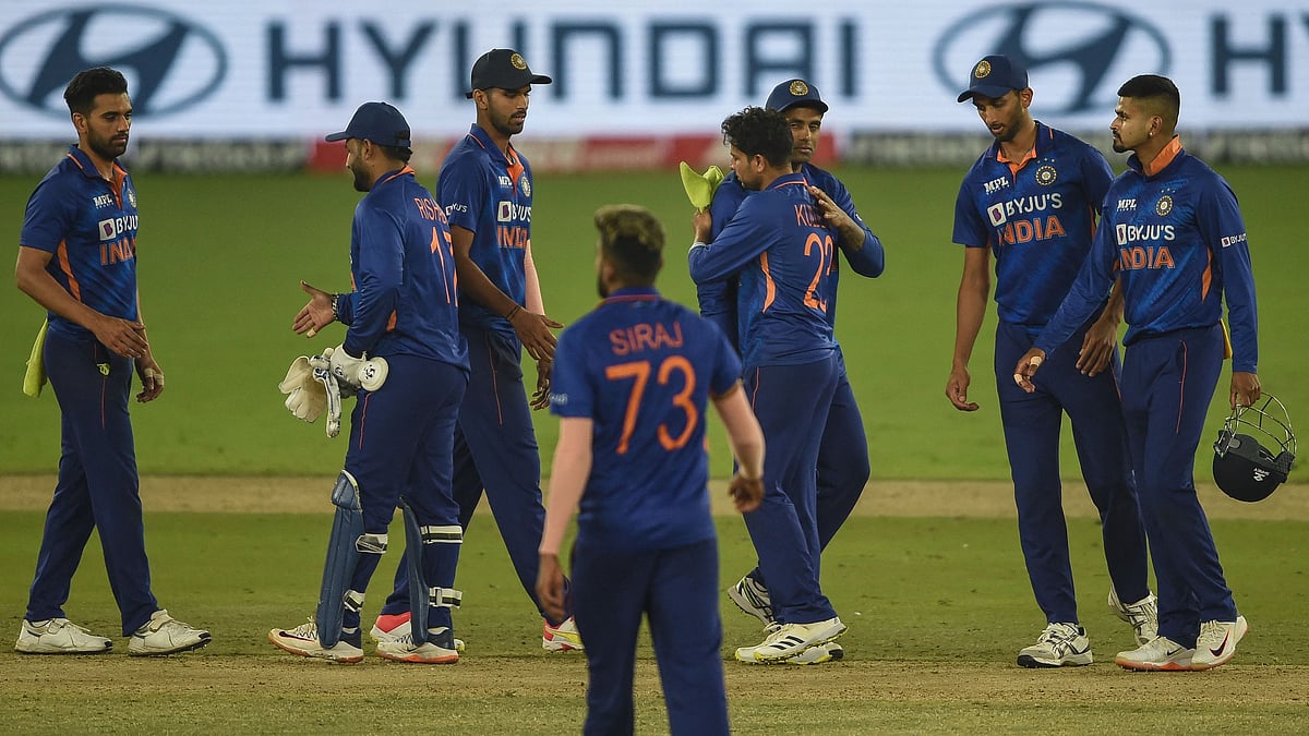 India's players celebrate their win against West Indies' after the end of play on the third and final one-day international (ODI) cricket match between India and West Indies at the Narendra Modi Stadium in Motera on 11 February 2022.