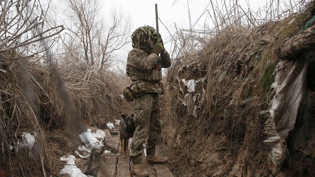 Ukrainian Territorial Defense Forces, the military reserve of the Ukrainian Armes Forces watches through spyglass on a trench on the frontline with Russia-backed separatists near to Avdiivka, southeastern Ukraine, on 9 January, 2022
