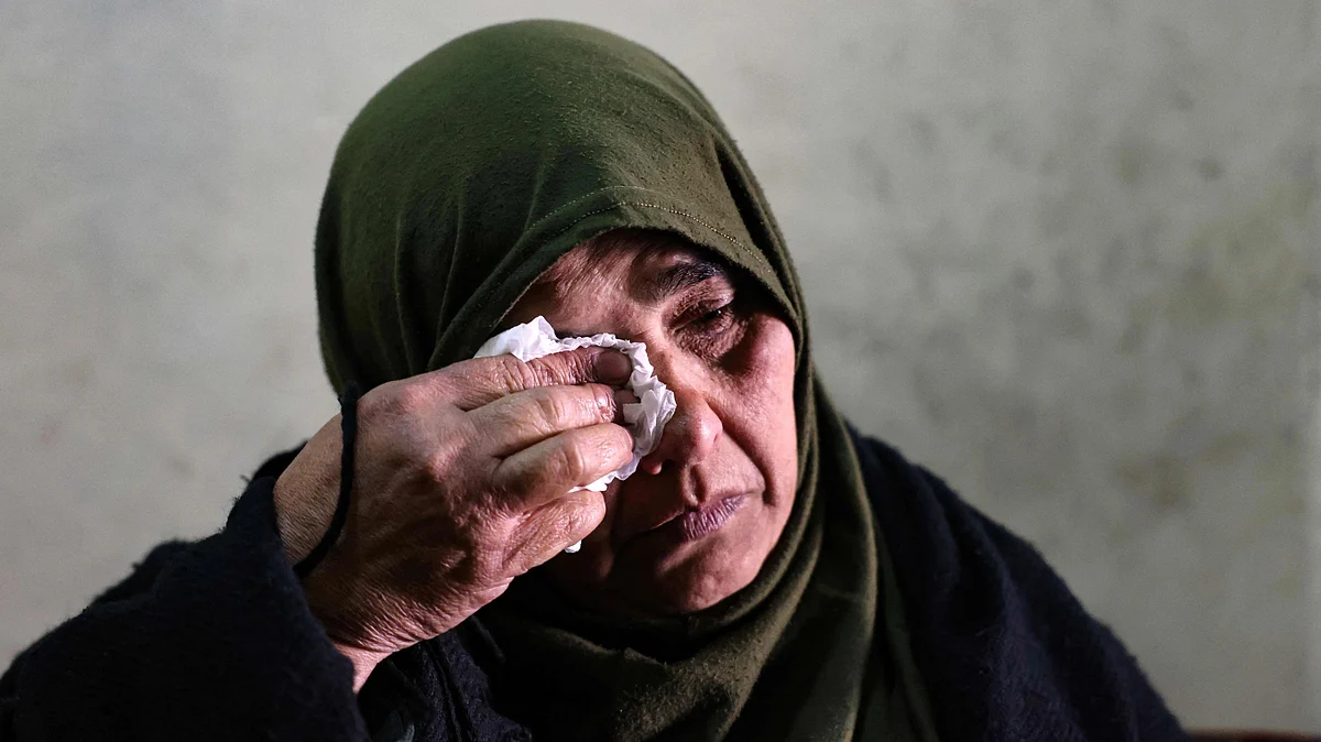 The mother of Omar Seif who disappeared from the northern Lebanese city of Tripoli's neighbourhood of Wadi al-Nahle sits in her living room during an interview with AFP, on 12 January, 2022