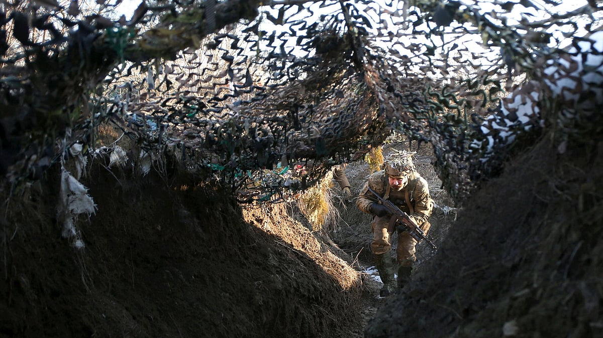 Ukrainian Territorial Defense Forces, the military reserve of the Ukrainian Armes Forces walks on a trench on the frontline with Russia-backed separatists near to Avdiivka, Donetsk, southeastern Ukraine, on 8 January 2022.