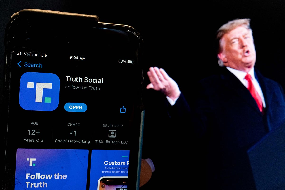 This photo illustration shows an image of former President Donald Trump next to a phone screen that is displaying the Truth Social app, in Washington, DC, on 21 February, 2022