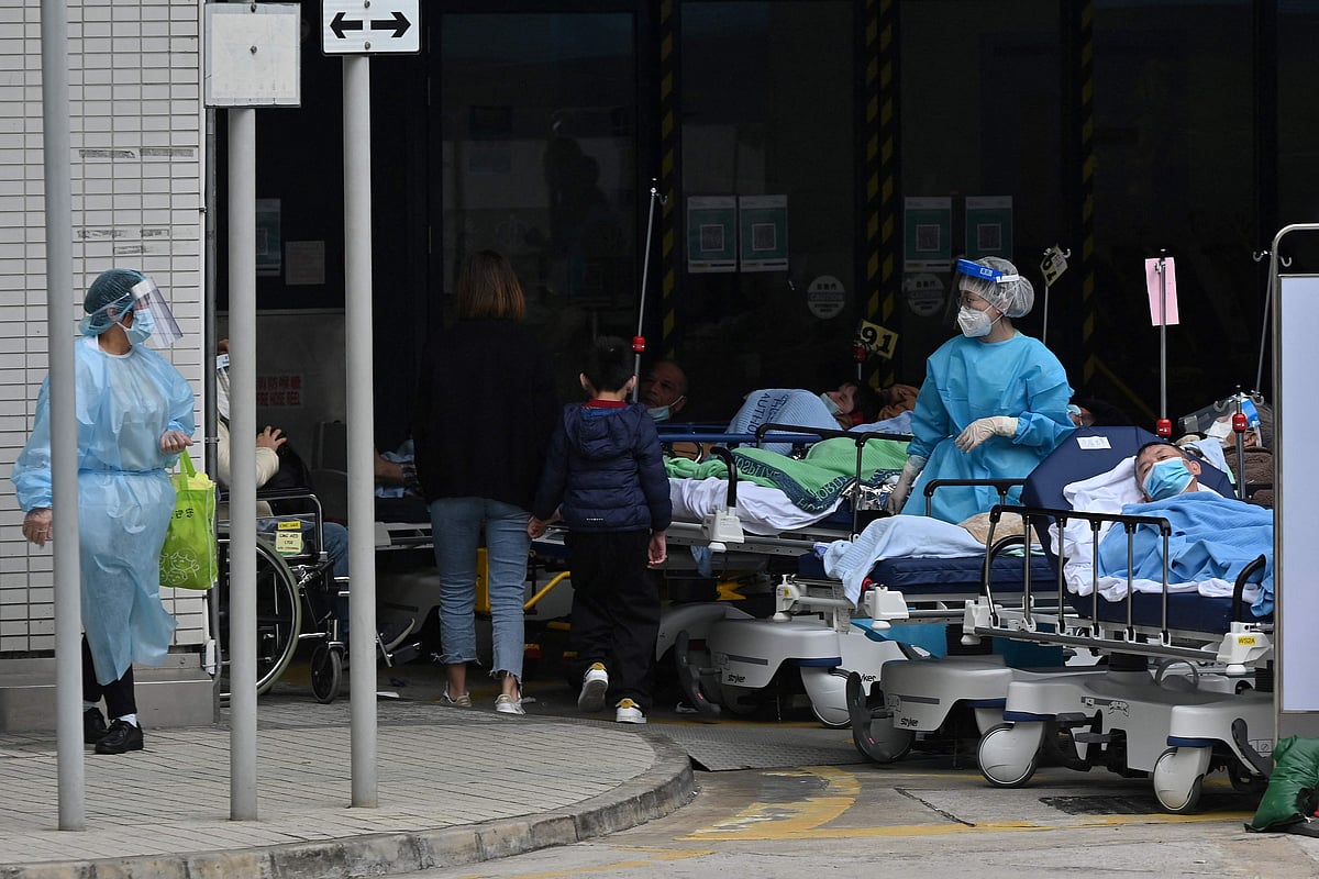 People lie in hospital beds outside the Caritas Medical Centre in Hong Kong on 18 February, 2022, as the city faces its worst Covid-19 coronavirus wave to date