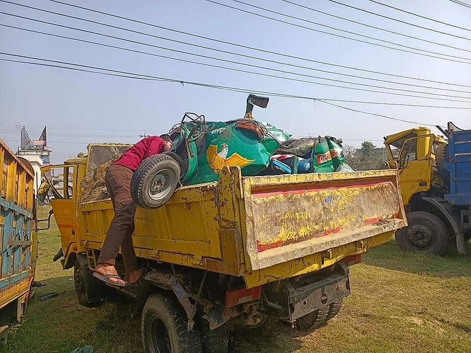The destroyed CNG-run auto-rickshaw is being taken away in Sindhuriapara Tutbagan area of Burichang upazila, Cumilla, on 18 February