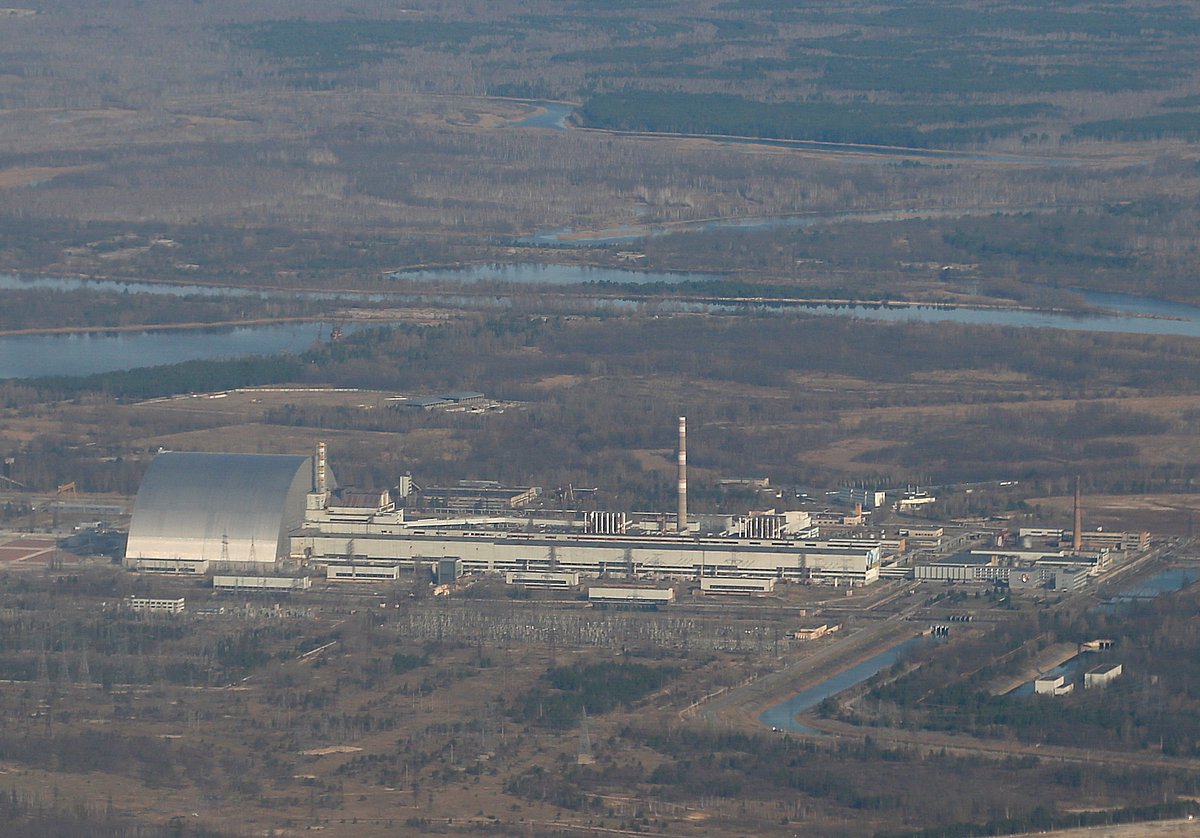 An aerial view from a plane shows a New Safe Confinement (NSC) structure over the old sarcophagus covering the damaged fourth reactor at the Chernobyl Nuclear Power Plant during a tour to the Chernobyl exclusion zone, Ukraine on 3 April, 2021